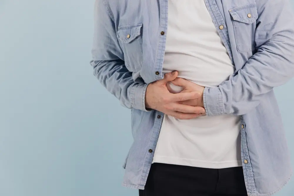 Man holding his lower abdomen due to discomfort caused by an abdominal hernia. 